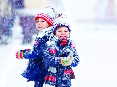 Happy-children-having-fun-with-snow-in-winter