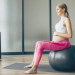 pregnant-woman-exercising-with-fit-ball-on-a-class-of-pilates